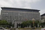 The Ministry of Commerce of the People's Republic of China headquarters building on Chang'an Avenue in Beijing under a cloudy sky