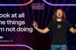 DHH on stage at Rails World 2026 with the slide text Look at all the things I'm not doing
