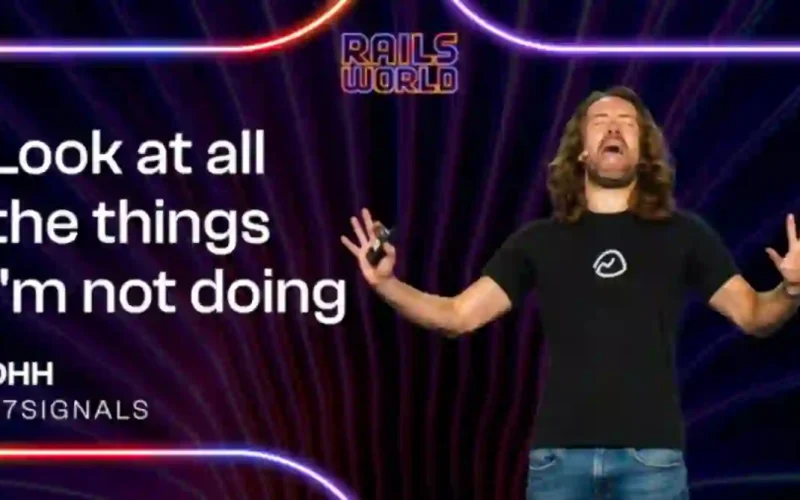 DHH on stage at Rails World 2026 with the slide text Look at all the things I'm not doing