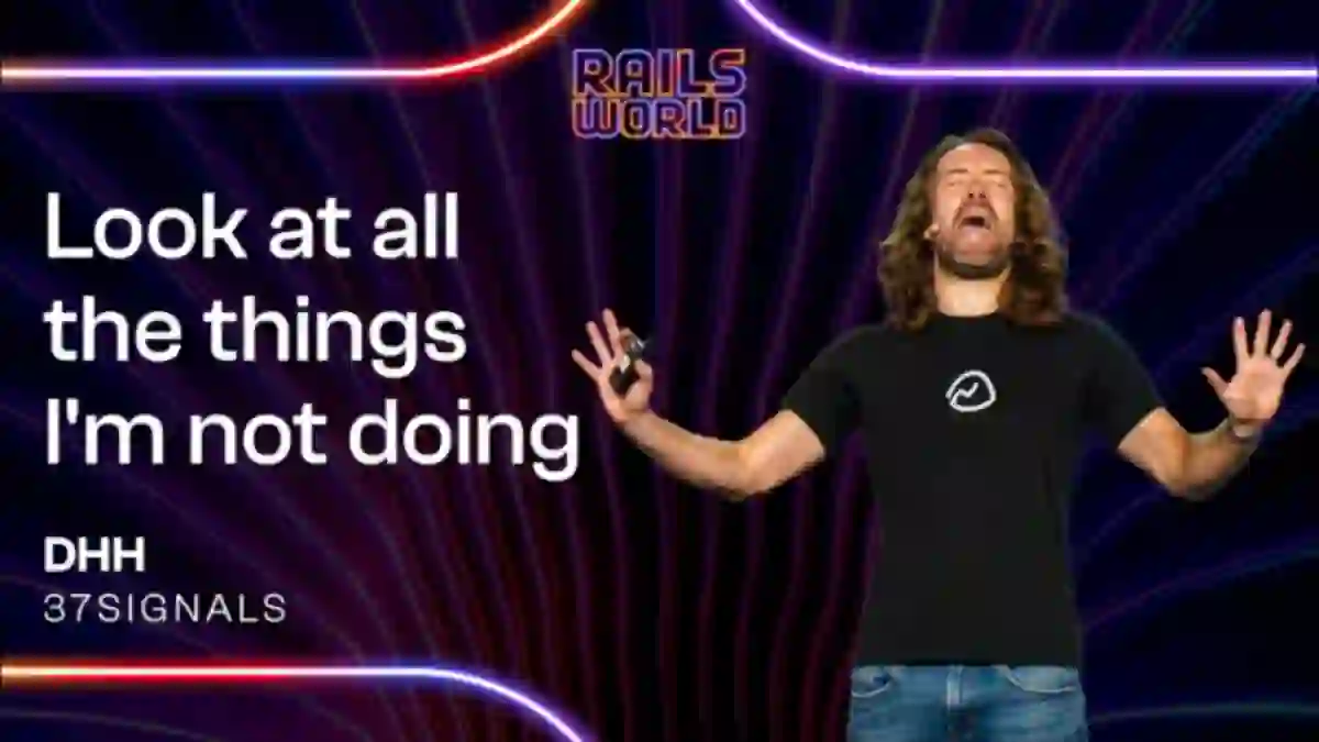 DHH on stage at Rails World 2026 with the slide text Look at all the things I'm not doing
