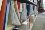 Law library shelf with Brooklyn Law Review volumes and visible gaps, an example scene from the Humanity's Sixth Sense benchmark