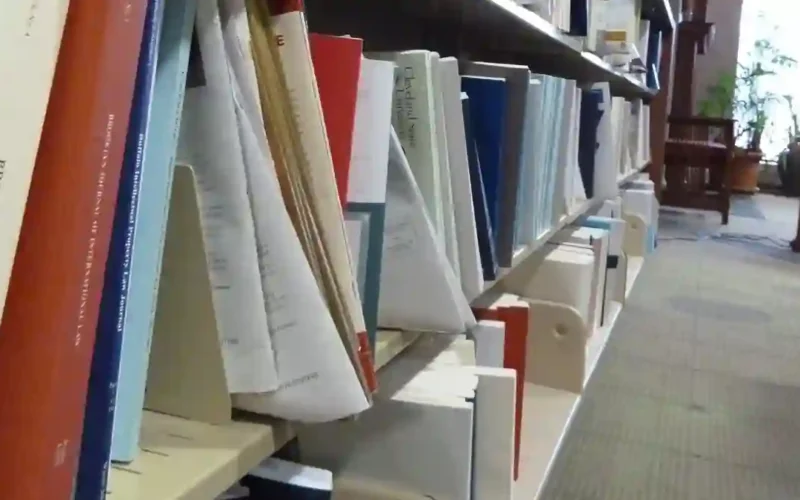 Law library shelf with Brooklyn Law Review volumes and visible gaps, an example scene from the Humanity's Sixth Sense benchmark