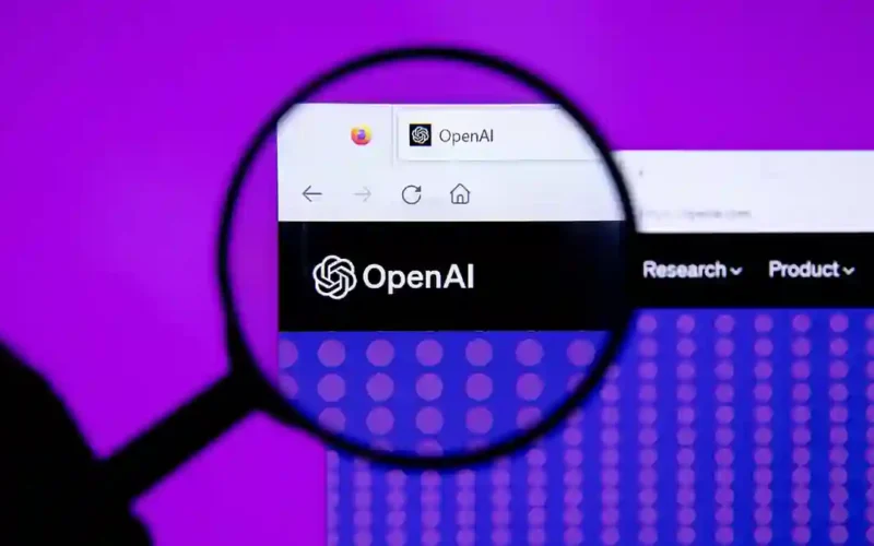 Magnifying glass over the OpenAI website logo on a purple background